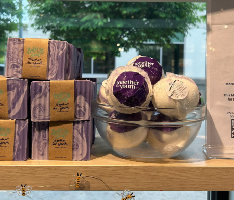 A glass bowl of round bath bombs labeled 